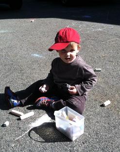 boy with chalk on driveway